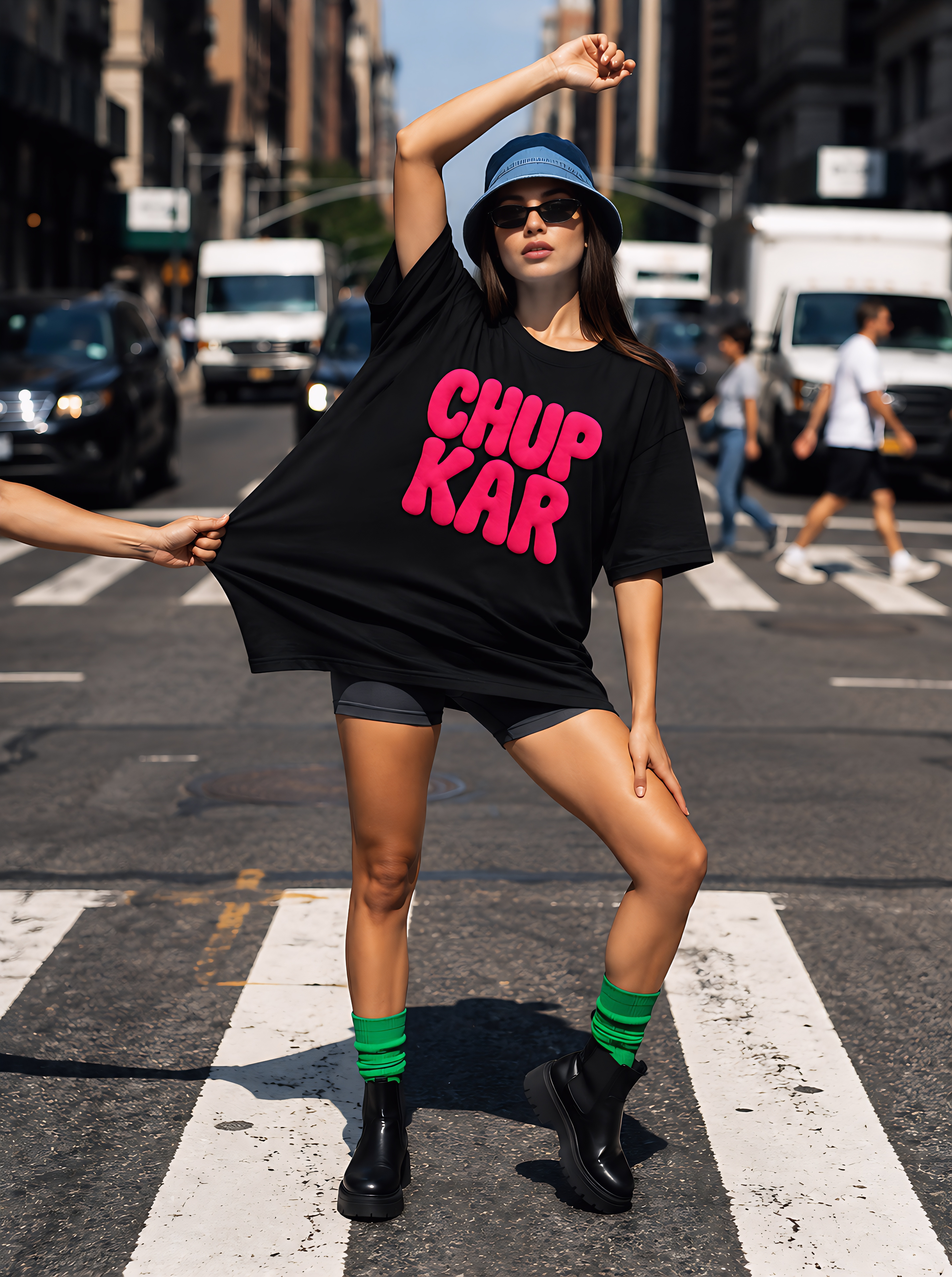 Model in the black Chup Kar tee on a city crosswalk